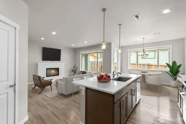 Virtually staged living, kitchen and dining.