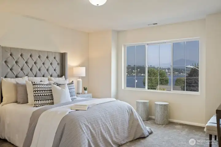 The primary suite with views of the lake form large picture window