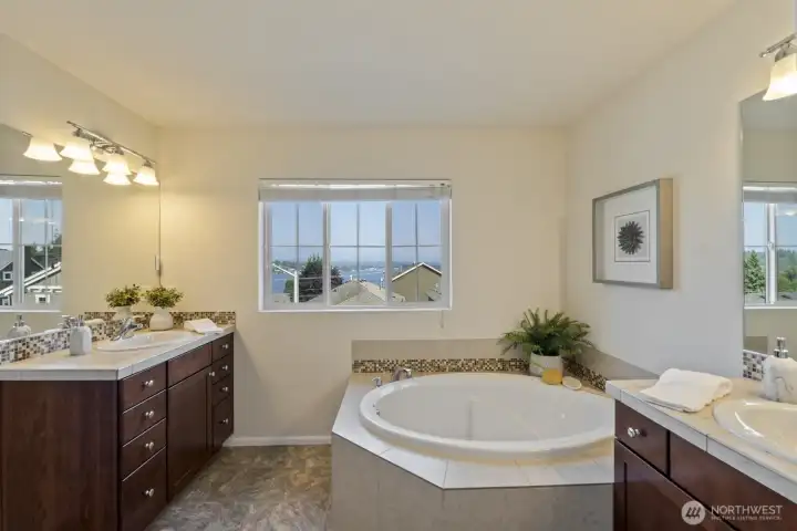 primary en-suite bath is a 5 piece bath with separate sinks, a soaking tub, shower and WC with its own door for privacy