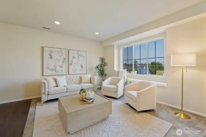Main level living room with lake views and a window bench!