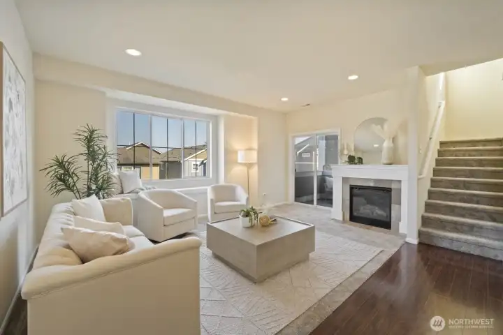 The living room showing the covered balcony and the stairs