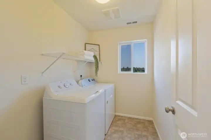 Upper level laundry room on the same level as primary and 2 add'l bedrooms
