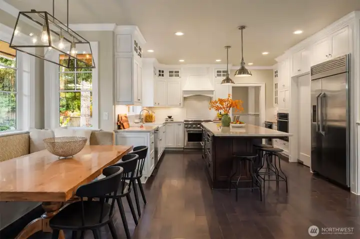 Stylish and functional kitchen space with charming breakfast  nook.