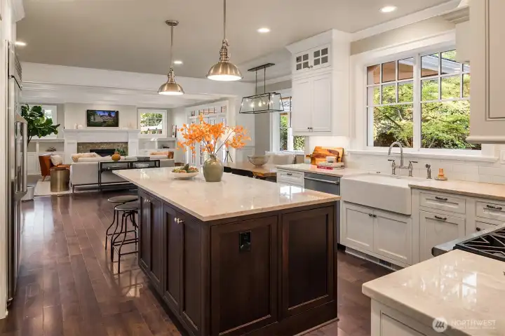 The updated, gourmet kitchen features a large center island, quartz countertops, and high-end stainless appliances.