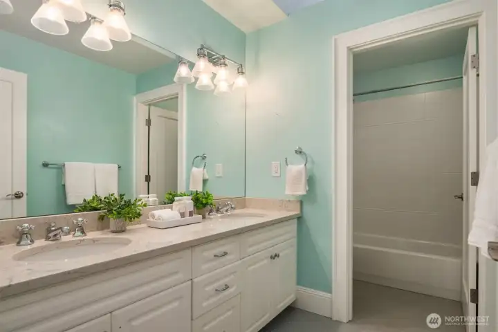 The guest bath features dual sink vanity with separate tub room.