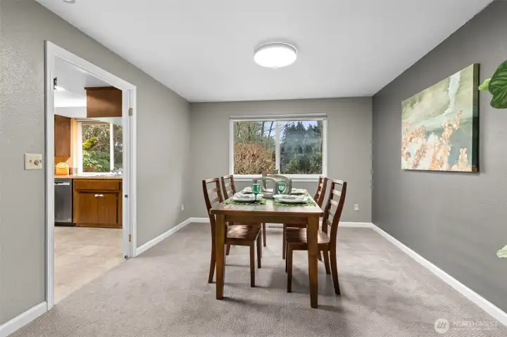 View the private back yard from the dinning area and watch the seasons change.  Plush carpet and handsome white trim and millwork highlight this lovely, timeless home.