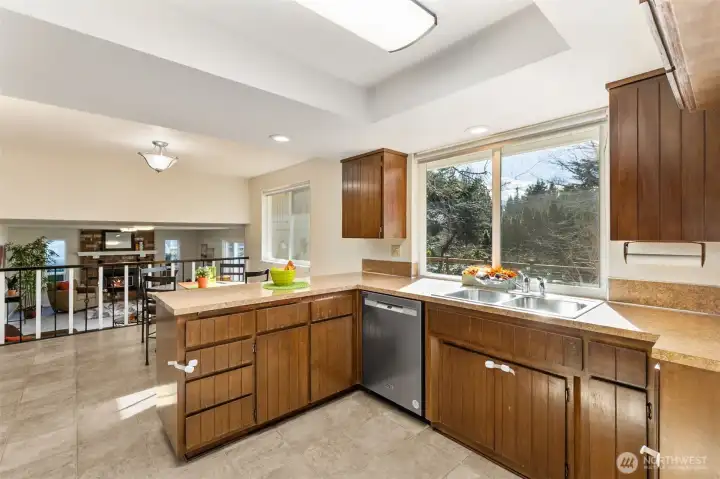 Recessed lighting, updated counter tops and practical, easy care laminate flooring make clean up a breeze.  Watch the backyard fun from the kitchen window, or enjoy a serene back yard with private view.