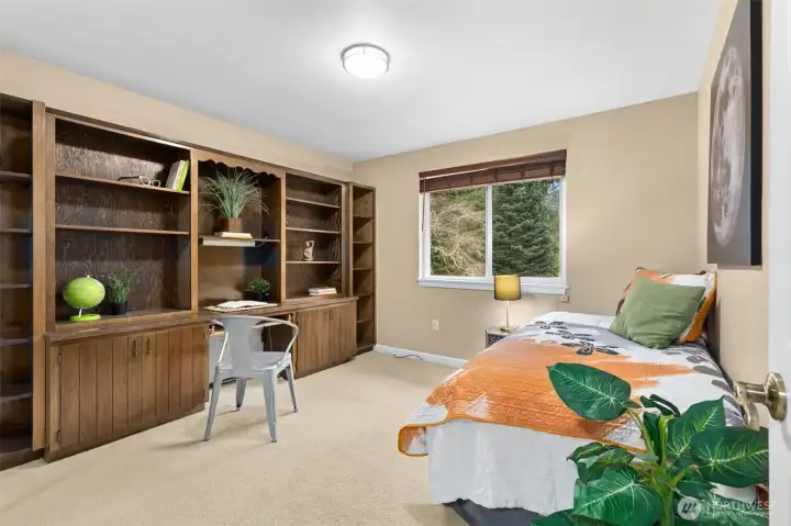 At the top of the stairway find the 4th bedroom/den combination room with a fantastic, built in work-station, desk and library shelving.  Room for a hide-a-bed or twin too.