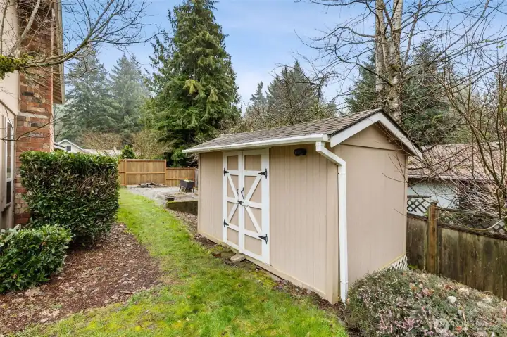 A double-wide front gate leads to the side garden area, with a convenient garden shed.