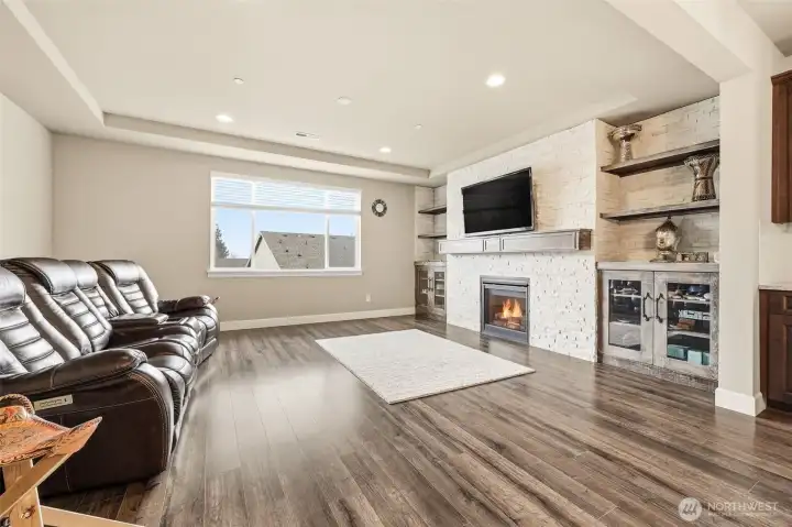 Built-in shelves and cabinets surrounding the updated stone fireplace