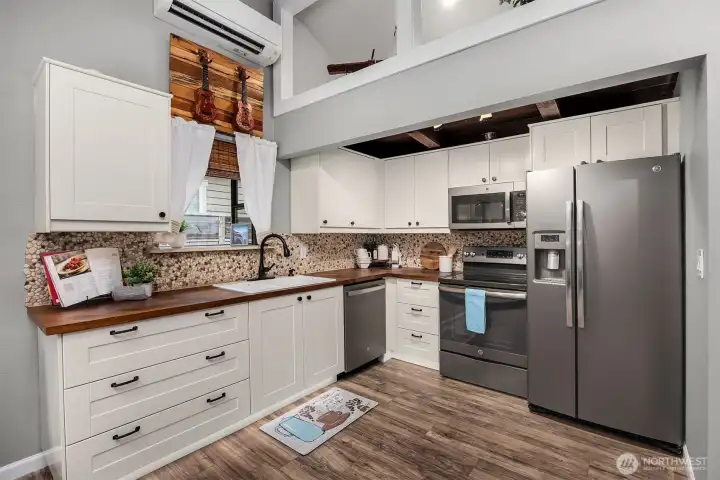 Newer appliances, butcher block countertops and undercounter lighting