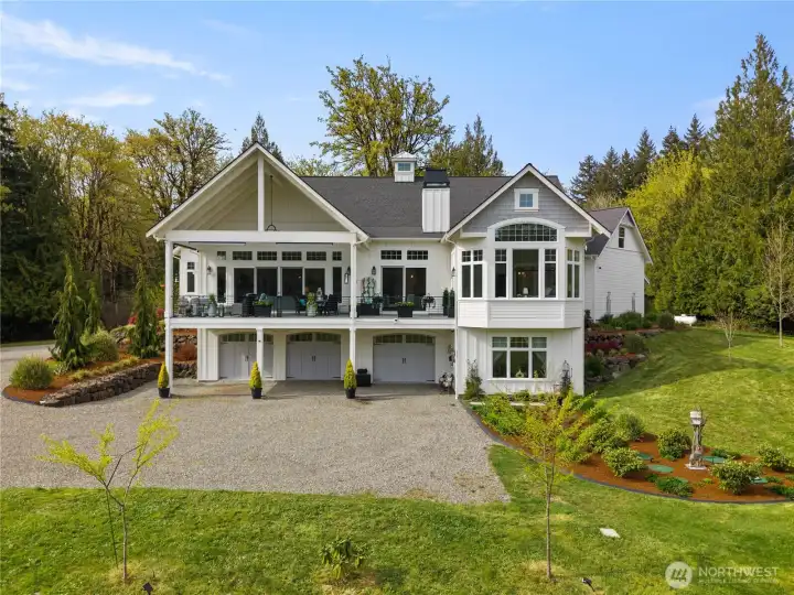 Commanding presence with lower lever 6 car garage. Views of the expansive patio with direct access from the living room, dining room and primary suite. Lower lever guest room. Gorgeous landscaping.
