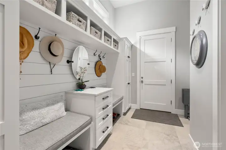 Hallway leading to downstairs and attached garage. Plenty of space for coats, shoes, and extra storage.