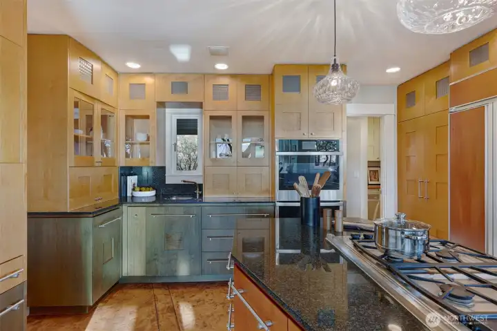 Tons of storage; Maple & Mahogany cabinets with granite countertops. Door to the right goes to a pantry and mud room