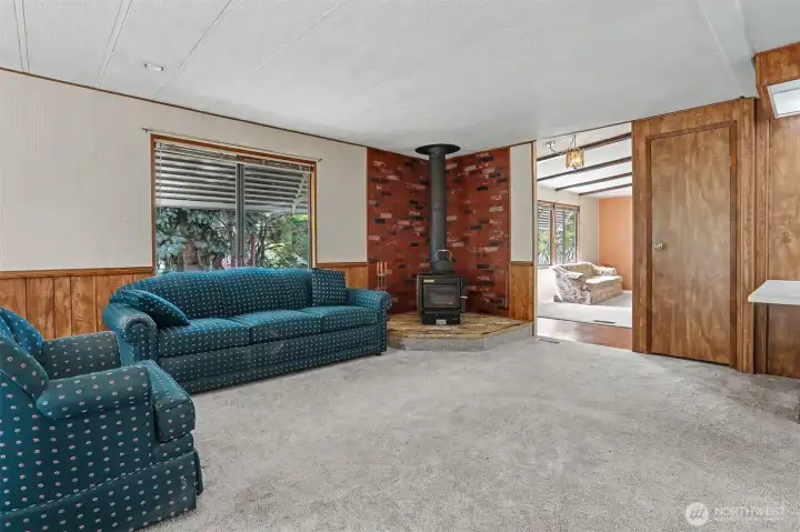 Family room with a fireplace and sliding door to the south facing wrap around deck with lake views