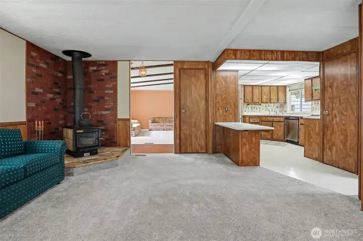 Family room with a fireplace and sliding door to the south facing wrap around deck with lake views