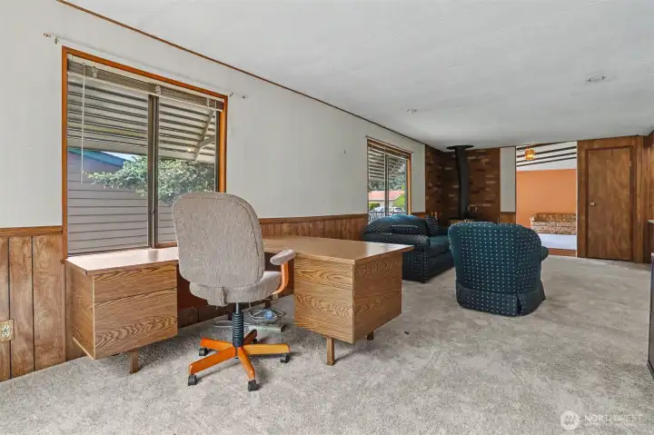 Family room with a fireplace and sliding door to the south facing wrap around deck with lake views