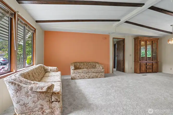 Formal living room with vaulted ceilings and western exposure.