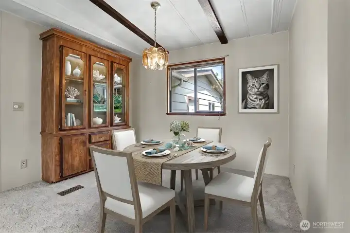 Formal dining room with vaulted ceilings and a built in hutch.  Virtually staged photo.