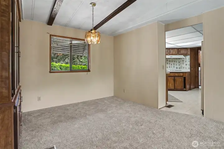 Formal dining room with vaulted ceilings and a built in hutch.