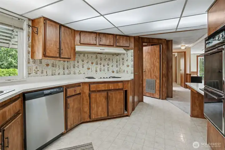 Spacious kitchen with quartz counters, eating bar that opens to family room.
