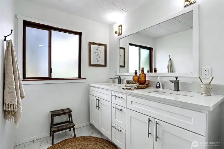 Master bedroom suite with a remodeled 4 piece bathroom with a full length walk  in shower.  Virtually staged photo.