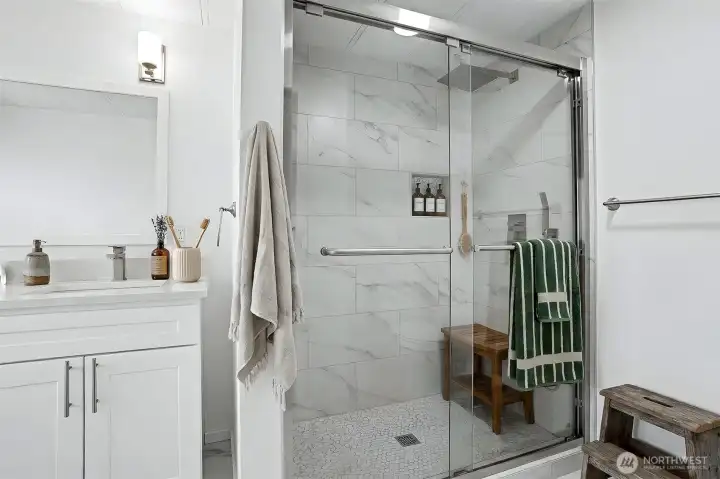 Master bedroom suite with a remodeled 4 piece bathroom with a full length walk  in shower.  Virtually staged photo.