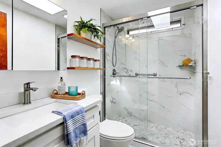 Remodeled 2nd bathroom with a full length walk in shower.   Virtually staged photo.