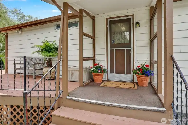 Back deck and patio covered porch.   Virtually staged photo.