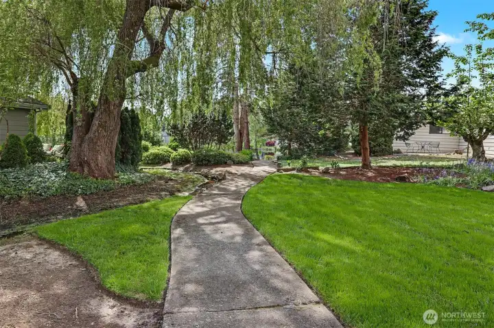 Community trail, greenbelt and creek in front of the house looking at Reflection Lake