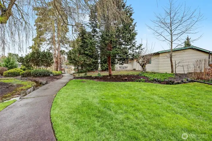 Community trail, greenbelt and creek in front of the house looking at Reflection Lake
