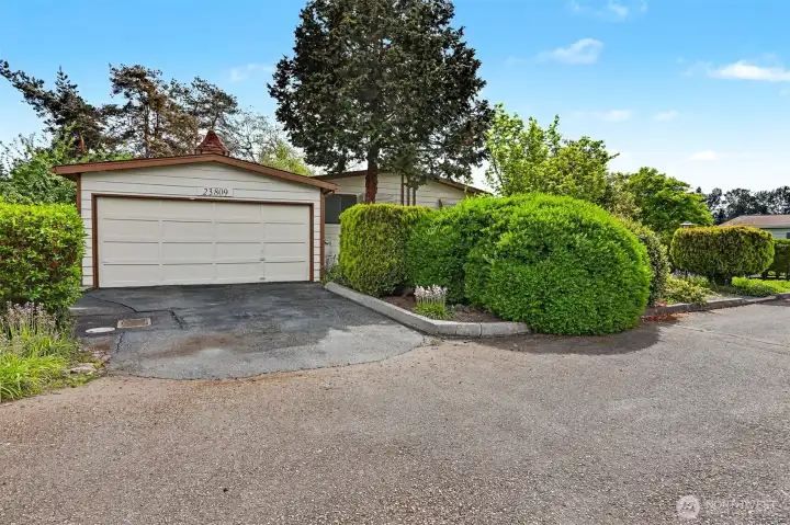 Detached 2 car garage with 2 uncovered driveway parking spaces.