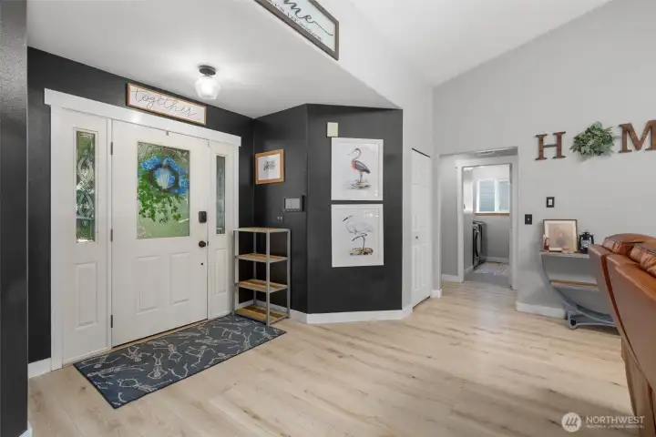 Step into the warm great room with vaulted ceilings and recent laminate flooring.