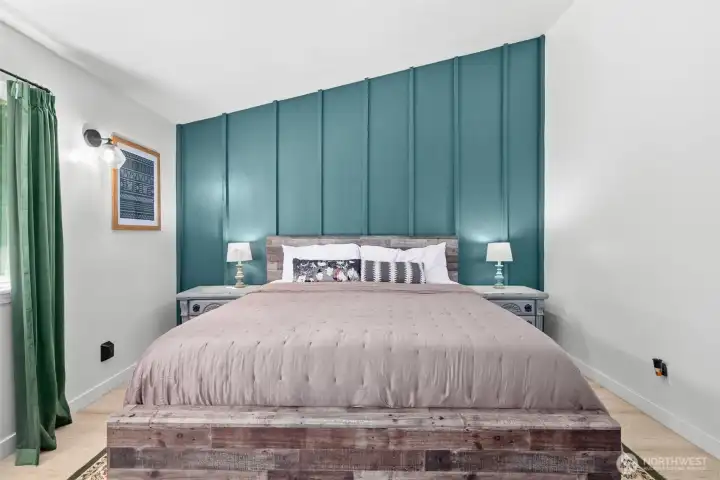 Primary bedroom with custom accent wall and direct access to the back deck and backyard.