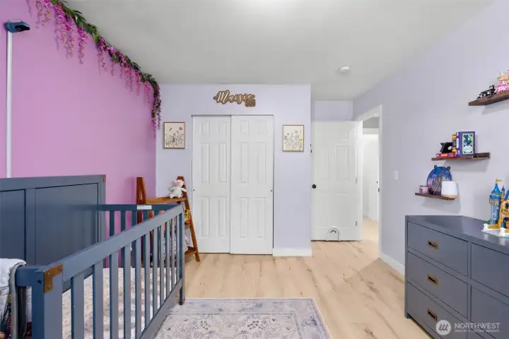 Bedroom 2 is just down the hall from the primary, and features the same laminate flooring for ease of maintenance.