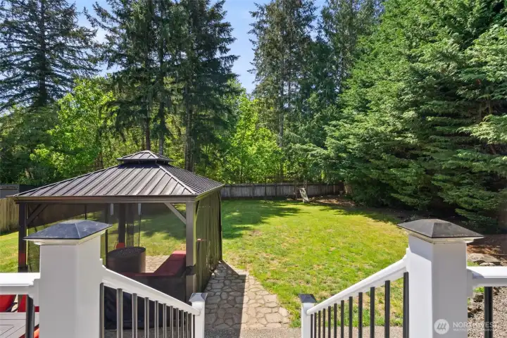 plenty of room in this flat, fully fenced backyard surrounded by mature trees