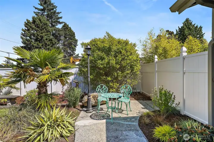 Manicured park-like landscaping with mature plantings and concrete-edged curbing throughout the front & back yards