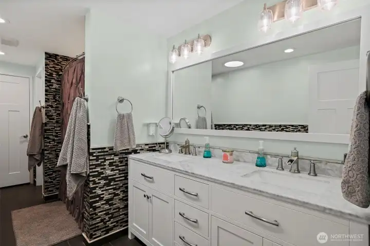 Custom built-in dedicated vanity area with a decicated mirror, extended counter space, and integrated lower cabinetry. All 3 Bathrooms Have Marble Countertops; Mozaic Tile in all Bathrooms;