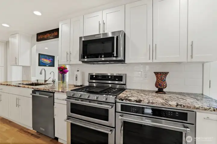 Fully Updated Kitchen; includes 3 separate Kitchen-Aid Professional oven-capable appliances: a built-in convection wall oven, a double-oven with gas range, and an overhead microwave/convection oven.