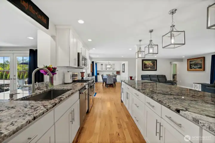 All granite countertops throughout kitchen/dining & on lower built ins around living room fireplace. Touchless kitchen faucet. Insta-hot/filtered cold water at kitchen sink.