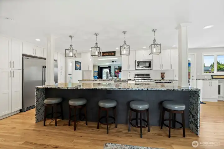 12 ft kitchen island is matching cascading granite waterfall.