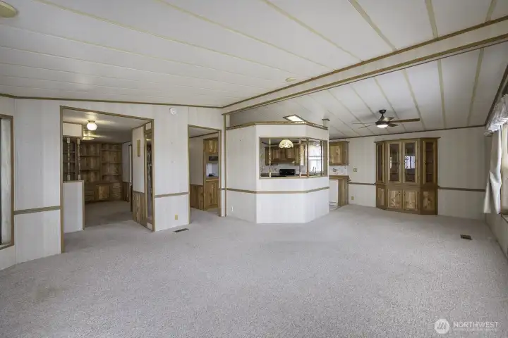 This large Living Room and Formal Dining Room with a built in Curio Cabinet.