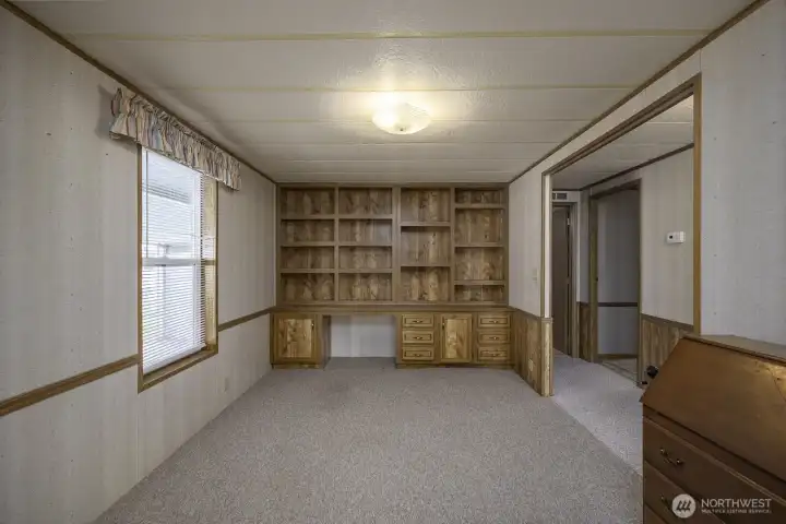 Office with built-in bookshelves, drawers, and a desk.