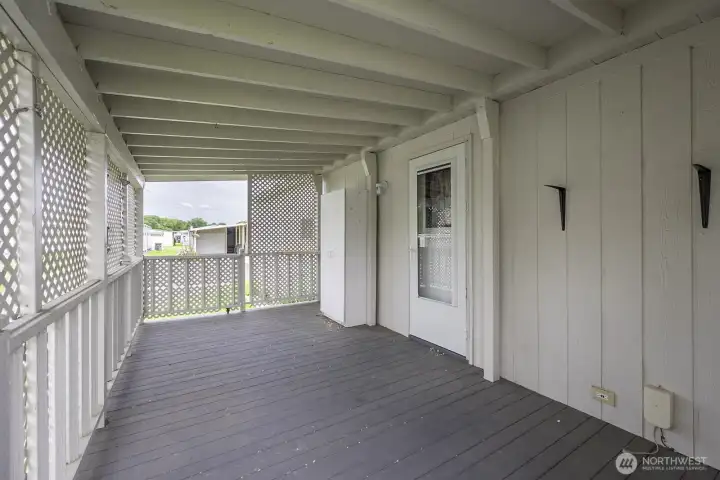 Covered back deck with plenty of space for a picnic table and chairs! Right off of the kitchen.
