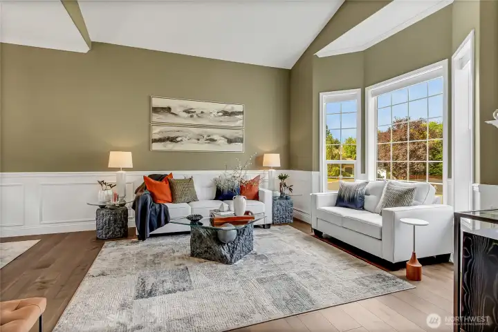The formal living room features cathedral ceilings, abundant natural light, and rich hardwood floors, creating an elegant yet welcoming space. The formal living room features cathedral ceilings, abundant natural light, and rich hardwood floors, creating an elegant yet welcoming space.