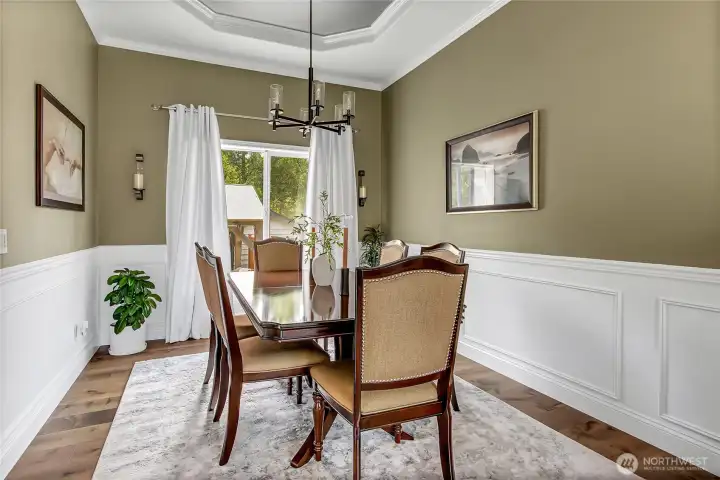 Elegant wainscoting and generous space make the formal dining room ideal for entertaining! Elegant wainscoting and generous space make the formal dining room ideal for entertaining!