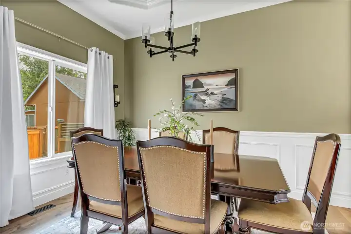Overlooking the beautifully landscaped backyard, the formal dining room offers an elegant setting for entertaining while capturing peaceful outdoor views and abundant natural light. Overlooking the beautifully landscaped backyard, the formal dining room offers an elegant setting for entertaining while capturing peaceful outdoor views and abundant natural light.