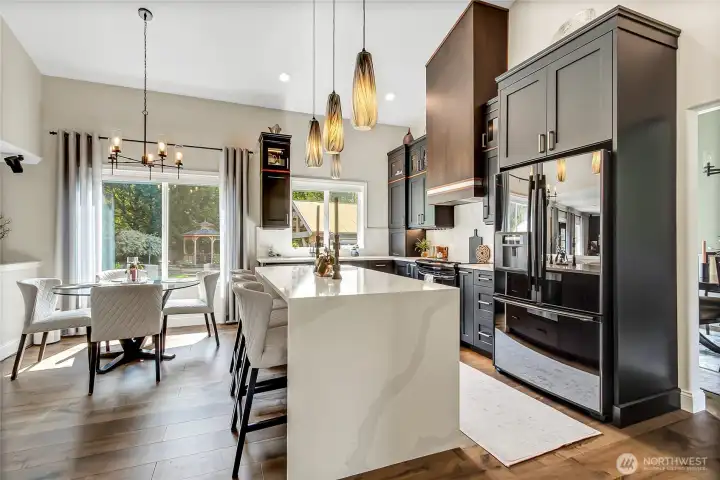Kitchen features custom alder perimeter cabinetry with tailored drawer interiors, blind corner accessory with sensor activated lighting, and appliance garage. Built in pantry w/ custom alder doors and 3 cm Silestone Quartz countertops and full height quartz backsplash! Kitchen features custom alder perimeter cabinetry with tailored drawer interiors, blind corner accessory with sensor activated lighting, and appliance garage. Built in pantry w/ custom alder doors and 3 cm Silestone Quartz countertops and full height quartz backsplash!