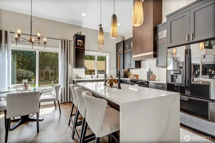 Luxury finishes include a custom blind-corner accessory with sensor-activated lighting, an appliance garage, and additional storage above the refrigerator. A built-in pantry with custom alder doors, sensor activated lighting, custom shelving, and matching upper storage provides exceptional organization. Luxury finishes include a custom blind-corner accessory with sensor-activated lighting, an appliance garage, and additional storage above the refrigerator. A built-in pantry with custom alder doors, sensor activated lighting, custom shelving, and matching upper storage provides exceptional organization.