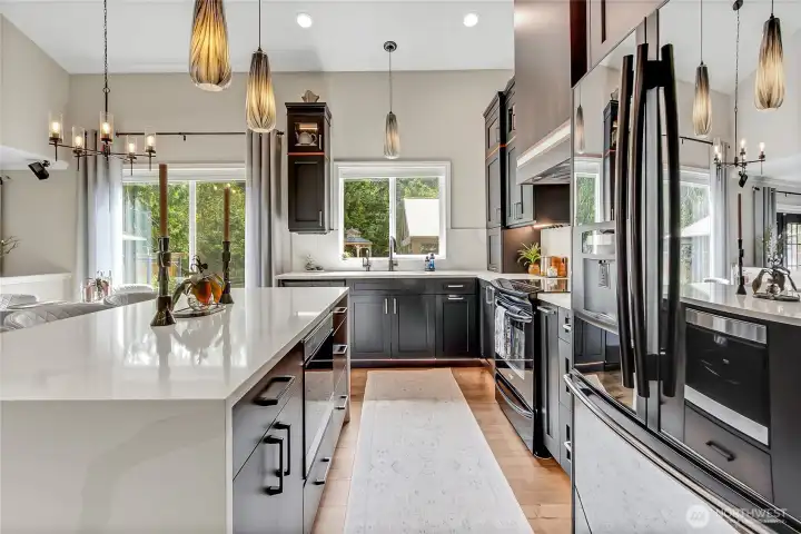 Additional standout features include a microwave drawer with convection oven, air fryer, WI-FI capability, and one-of-a-kind hand blown glass Bridgette pendants. Additional standout features include a microwave drawer with convection oven, air fryer, WI-FI capability, and one-of-a-kind hand blown glass Bridgette pendants.